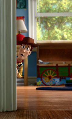 the toy story movie character is peeking out from behind a wall in a room with wooden floors