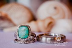 two wedding rings sitting on top of a table