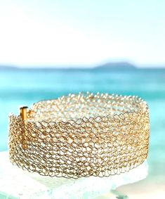 This luminous bracelet will make you feel like a princess when you wear it in the sunshine! The sparkling is off the charts, in this lightweight mesh golden bracelet. This is woven from one continuous piece of 14k gold filled wire. Gold filled is a layer of gold much thicker than a plating, and does not come off. A little soap and water to remove oils is all you need to do.  This is a standard 7.5" bracelet, and the height is 2". Message me if you need a different size, no extra charge. Elegant Yellow Gold Beach Bracelets, Luminous Bracelet, Golden Bracelet, Wire Crochet, Mesh Bracelet, A Princess, The Sunshine, Cuff Bracelets, Metallica