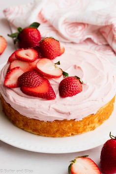 there is a cake with strawberries on the top and frosting in the middle