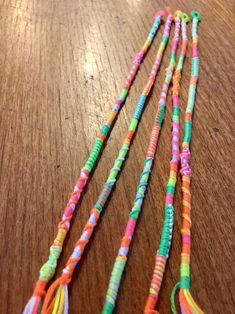 three different colored beads on a wooden table with one beaded and the other stringed