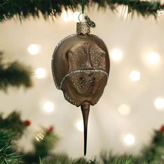 a glass ornament hanging from a christmas tree