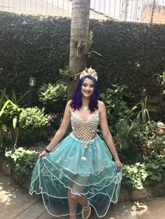 a woman in a costume standing on a wooden floor