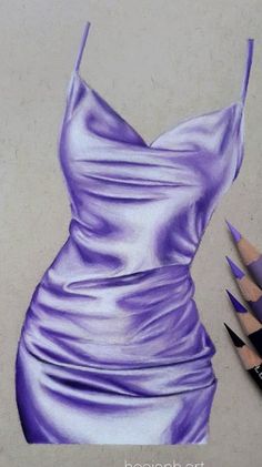 a pencil drawing of a purple dress and two colored pencils next to it on a white surface