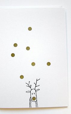 a card with a drawing of a reindeer blowing gold dots on it's nose