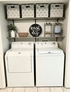 a washer and dryer in a laundry room with baskets on the shelves above them