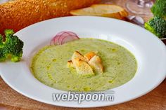 broccoli soup with croutons and bread on the side, ready to be eaten