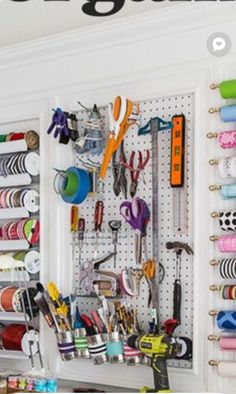 there are many crafting supplies on the wall in this room and it's organized