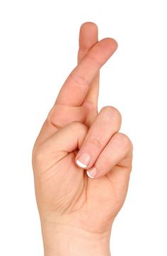 a woman's hand making the v sign with her fingers, against a white background