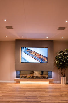 a large flat screen tv mounted to the side of a wall in a living room