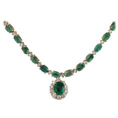 29.75 Carat Natural Emerald 14K Solid Yellow Gold Diamond Necklace Item Type: Necklace Item Style: Tennis Item Length: 17 Inches Material: 14K Yellow Gold Mainstone: Emerald Stone Color: Green Center Stone Weight: 1.70 Caratn (9.00x7.00 mm) Other Stones Weight: 26.00 Carat (6.00x4.00 mm) Stone Shape: Oval Stone Creation Method: Natural Stone Treatment Method: Oiled Gemstone 1: Diamond Stone Color: F-G Stone Clarity: VS2-SI1 Stone Weight: 2.05 Carat Stone Shape: Round Stone Creation Method: Natural Stone Treatment Method: Not-treated Total All Stones Weight: 29.75 Carat Total Metal Weight: 19.4 Grams Face Measures: 14.05x12.45 mm Gender: Women Condition: New Made in: USA SKU: 704573 White Gold Sapphire Ring, Solid Necklace, Ruby And Diamond Necklace, Yellow Diamond Rings, White Sapphire Ring, Black Diamond Ring, Gold Diamond Necklace, White Gold Necklaces, Green Diamond