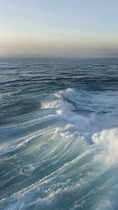 the ocean is blue and green with waves