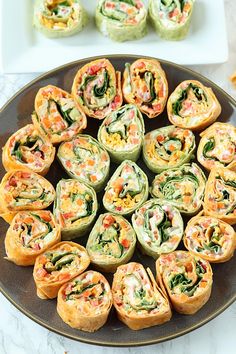 an assortment of appetizers are arranged on a platter, ready to be eaten