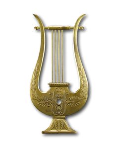 a golden instrument that is sitting on a white surface