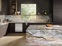 a kitchen with marble counter tops and cabinets