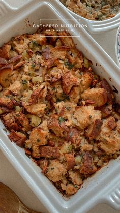 a casserole dish filled with stuffing next to two bowls full of other food