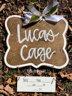 a wooden sign that says lucas's garage with a bow on the front and side