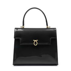 Traviata Handbag in Patent Black/BlackLauner's most famous design. Instantly recognizable as the go-to-handbag of H.M. Queen Elizabeth II and the Queen Mother, these elegant soft leather handbags are crafted entirely by hand in England. Each piece is made-to-order, following the exacting standards of the client. The leather is imported from Italy and only butter-soft, unblemished hides are chosen by their leather buyer. Every piece has perfectly rounded corners and smooth, turned-edging- a hallm Launer London, Luxury Leather Bag, Soft Leather Handbags, Isabel Ii, Top Handle Handbags, Iconic Bags, Queen Elizabeth Ii, Elizabeth Ii, Small Leather Goods