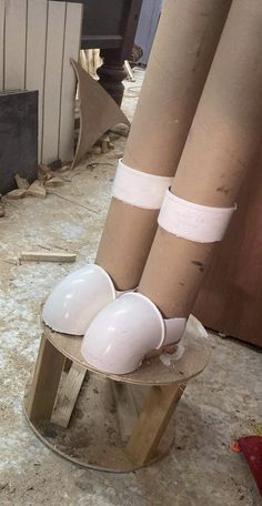 two white balls sitting on top of a wooden stand