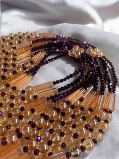 Why You'll Love It: Striking Design: The rich purple crystal glass beads paired with the warm golden sandy brown accents create a luxurious and timeless aesthetic. Premium Quality: Crafted with high-quality glass beads, ensuring durability and lasting brilliance. Comfortable Fit: The elastic design offers a comfortable and flexible fit for all-day wear. Versatile Style: Perfect for everyday wear, special occasions, or as a thoughtful gift. Cultural Significance: Purple: In Ivorian culture, purple symbolizes royalty, wisdom, and spirituality. The purple beads in the Lakota Waist Bead embody these qualities, adding a regal touch to your style. Golden Sandy Brown: Representing warmth, stability, and connection to the earth, the golden sandy brown accents bring a grounded elegance to the desig Elegant Amber Crystal Necklaces With Round Beads, Elegant Amber Crystal Necklace With Round Beads, Round Gemstone Beads For Party, Party Crystal Necklaces With Polished Round Beads, Gemstone Beads Crystal Necklace For Party, Gold Crystal Necklaces With Round Beads For Party, Party Crystal Necklaces With Gemstone Beads, Party Crystal Necklaces With Round Gemstone Beads, Elegant Amber Crystal Necklaces With Polished Beads