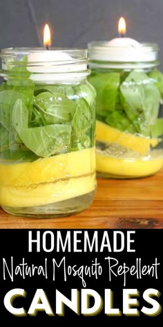 two mason jars with lemons and spinach in them on a wooden table next to candles