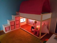 a child is sitting on the bottom bunk of a loft bed with pink and white furniture