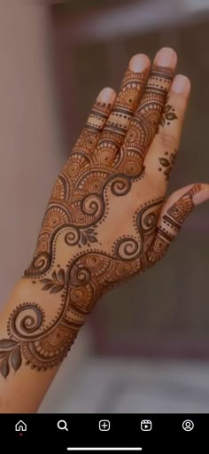 a woman's hand with henna on it