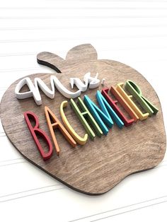 an apple shaped sign with the word baumeer spelled in multicolored letters