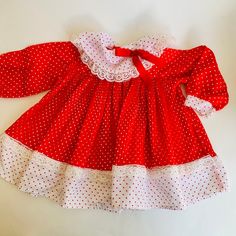 Vintage red and white polka dot baby dress from Sears. Such a fun piece with  lace, a big bow and pleats for days. The piece is listed as a size medium 28.5": x 32", 21 to 26 pounds. . It measures laying flat: shoulder to hem 14.5" x under arm to under arm 11.5. It is in very good vintage condition. It will need to be pressed upon arrival. Shipping is included in the price. (Shipping may be listed as free- but of course its not really free...) We believe in transparency and honesty even in marketing and want you to know we are just including shipping in your purchase price.  We use USPS ground mail when ever possible. If you need an International quote or faster shipping send over a message with details and we will get you a quote. We love being able to save you so if you purchase multiple Polka Dot Ruffle Dresses For Playtime, Red Cotton Dresses With Doll Collar, Red Cotton Dress With Doll Collar, Vintage Baby Dress, Vintage Baby Dresses, Big Bow, Red Polka Dot, Big Bows