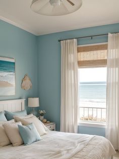 a bedroom with blue walls and white bedding