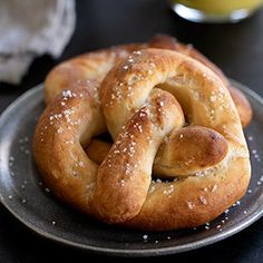 two pretzels on a plate with sugar sprinkled on them