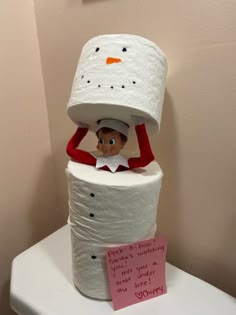 a toilet paper roll with a cat in the hat on top of it and a note attached to it