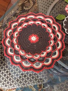 a crocheted doily is sitting on top of a table with other doilies