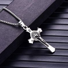 This classic religious pendant necklace is exceptionally made from high-class quality stainless steel that features a Christian designed pendant. Highly polished, to achieve the desired durability, perfect for all men who want attention. Elevate any of your trendsetting church attire by complementing it with a piece of highly polished jewelry like this. Focus on your fashion statement and be the star this season by wearing this glorious masterpiece.  Product highlights:   Perfectly detailed cros Father's Day Stainless Steel Cross Pendant Necklace, St Benedict Cross, St Benedict Medal, Cross Medal, Benedict Medal, Cross Wall, St Benedict, Christian Designs, Rock Jewelry