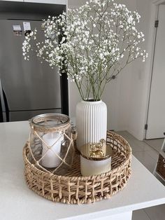 a wicker tray with flowers and candles on it