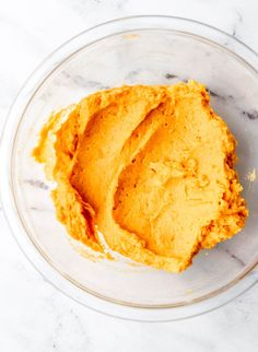 a glass bowl filled with mashed sweet potatoes