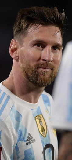 a man with a goatee and beard standing in front of an audience at a sporting event