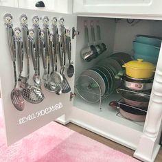 an open cabinet filled with pots and pans