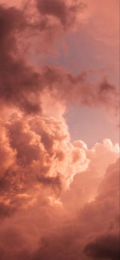 the airplane is flying high in the sky with clouds behind it and one plane on the ground