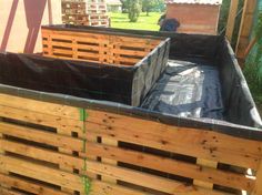 two wooden crates with tarp on them