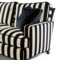 a black and white striped couch with pillows