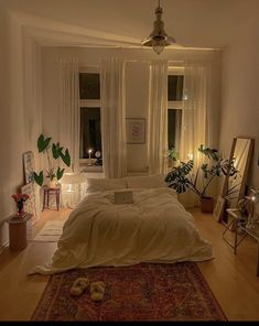 a bed sitting in a bedroom on top of a wooden floor next to a window