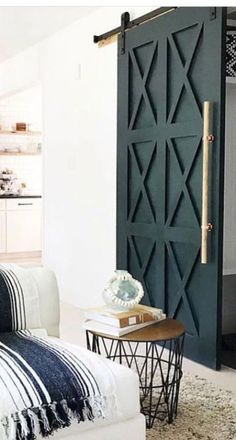 a living room filled with furniture and a sliding door in the middle of it's wall