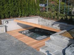 an outdoor hot tub with steps leading up to it