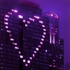 the building is lit up in purple light