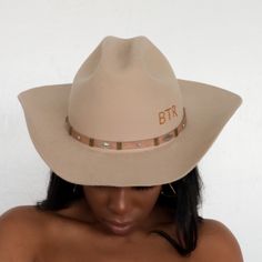 The Upland Western Cowboy Hat seamlessly blends the rustic charm of the Wild West with a dash of futuristic boho flair. With its distinctive cowboy silhouette, complete with a cattleman creased crown and a stylish upturned brim, this hat exudes classic Texan allure. The leather band is adorned with gleaming silver jewels, adding a contemporary twist to this timeless fashion statement. Handcrafted and meticulously embroidered with the initials "BTR," this hat exemplifies the perfect fusion of tra Western Style Fedora With Flat Crown, Flat Crown Hat For Kentucky Derby, Western Style Short Brim Hat For Rodeo, Western Style Rodeo Hat With Short Brim, Rigid Hat With Curved Brim For Western-themed Events, Rigid Curved Brim Hat For Western-themed Events, Flat Crown Hats For Kentucky Derby And Western Events, Western Curved Brim Hat For Rodeo, Rigid Flat Crown Hat For Rodeo