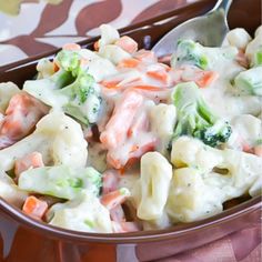 a close up of a bowl of food with broccoli and pasta in it