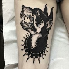 a woman's leg with a black and white tattoo design on it