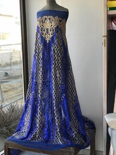 Gold and cobalt blue sequins lace fabric Rich fabric for evening formal gown Width is 135 cm Price is for one yard all order over quantity 1 will be in a continuous length Blue Sequined Gown For Banquets, Blue Sequined Gown For Banquet, Blue Lace Evening Dress For Banquet, Blue Sequined Floor-length Evening Dress, Blue Sequined Evening Dress For Wedding, Festive Lace Gown With Sequins, Festive Floor-length Blue Embroidered Fabric, Festive Blue Floor-length Embroidered Fabric, Fitted Floor-length Blue Embroidered Fabric