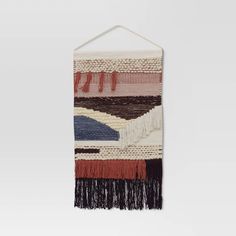 a multicolored wall hanging with fringes